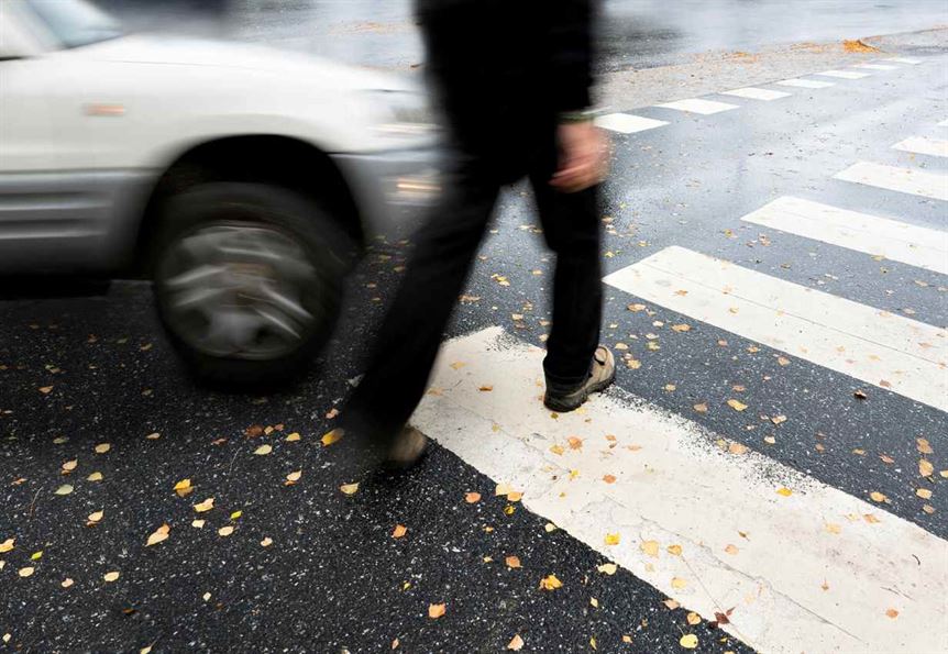 A person walking across a crosswalk

AI-generated content may be incorrect.